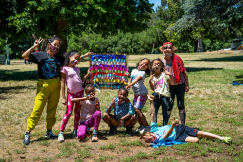 Camp Destiny Leader Francesca with group of youth in a park.